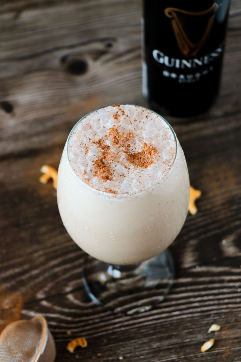 A glass of chilled Guinness punch with a dusting of cinnamon on the top.