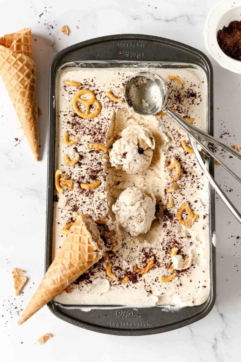 A loaf pan full of stout ice cream with pretzels and chocolate drizzle. Along with cones on the side.