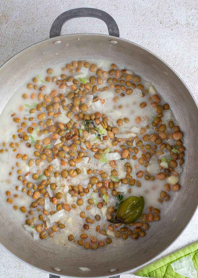 Pigeon peas and rice with water and coconut milk with fresh herbs and spices.