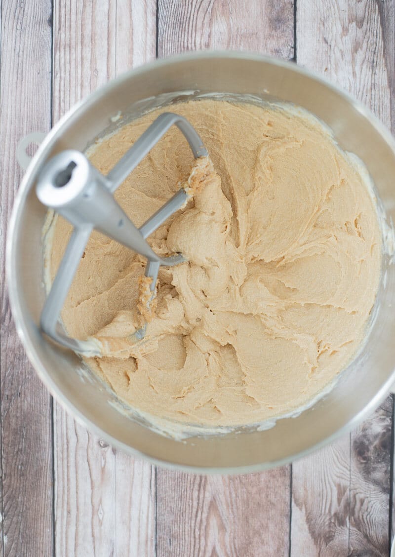 Creamed butter and sugar in a silver mixing bowl.