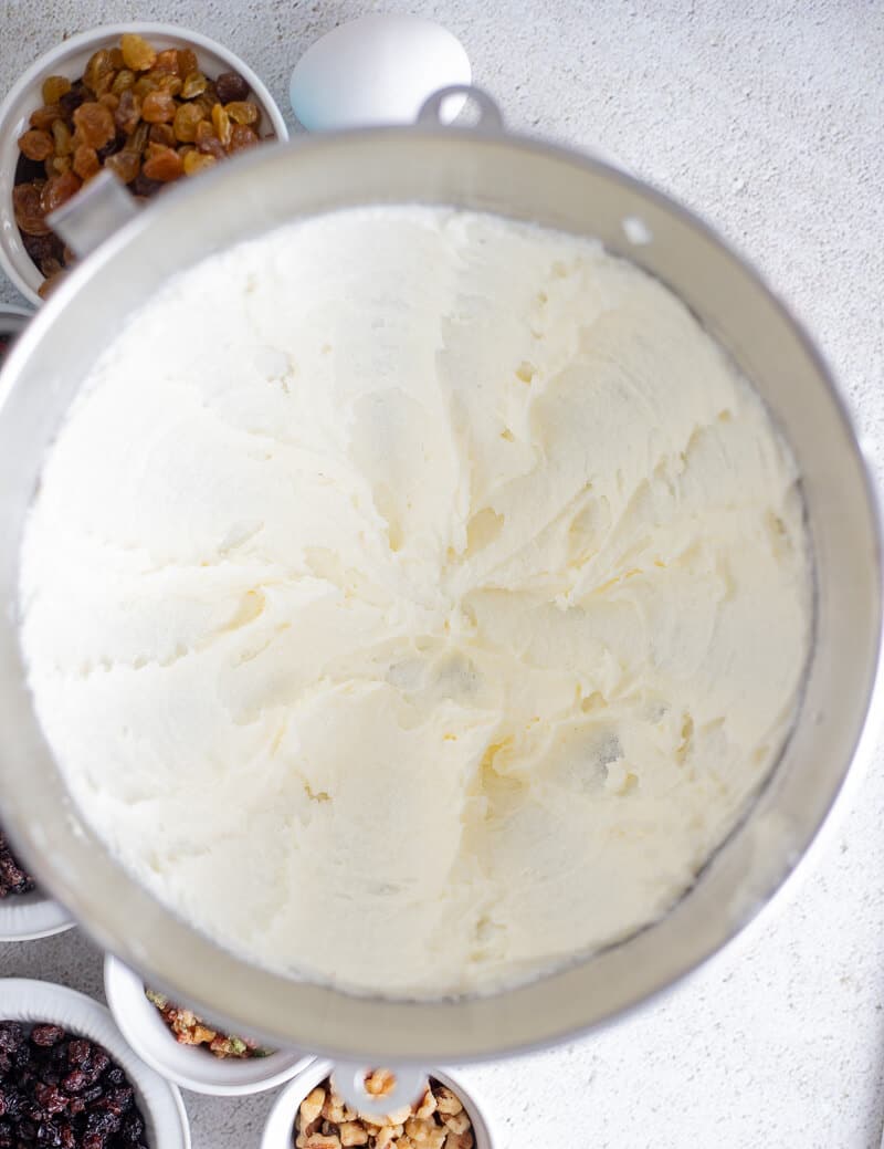 Creamed mixture of butter and sugar in a silver mixing bowl.
