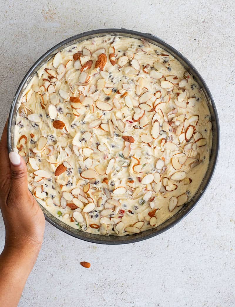 Cake batter covered with almonds.