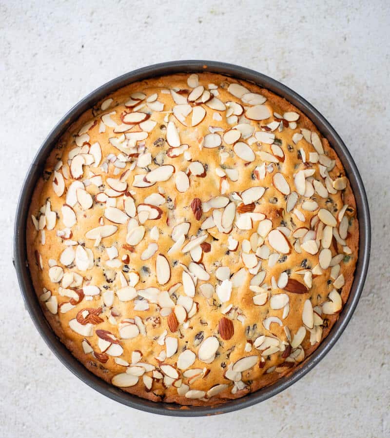 Baked golden dundee cake in a spring form pan. 