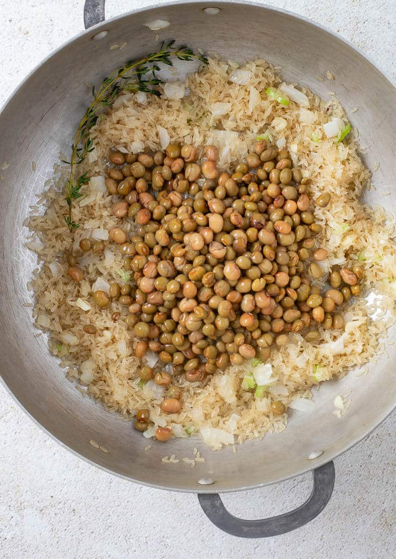 Pigeon peas and rice in pot being combined.