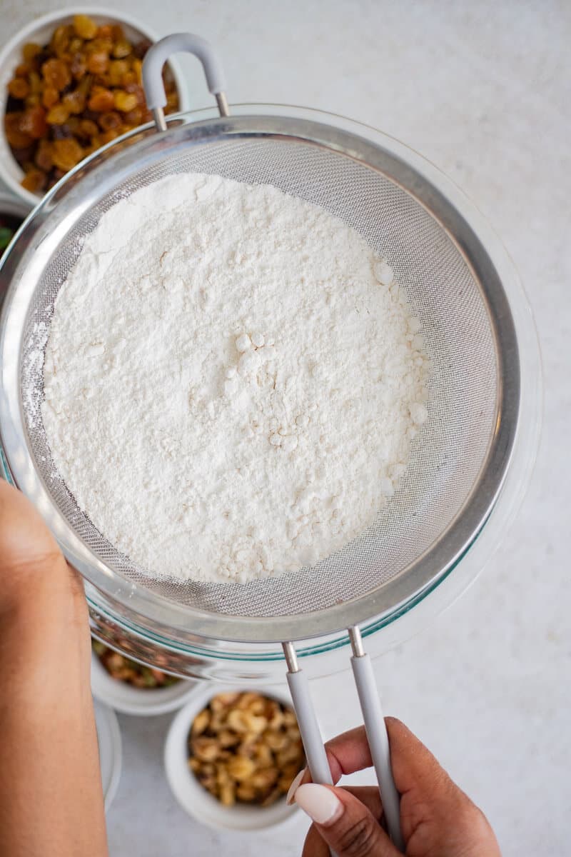 Flour, powder and salt sifted together in a bowl.