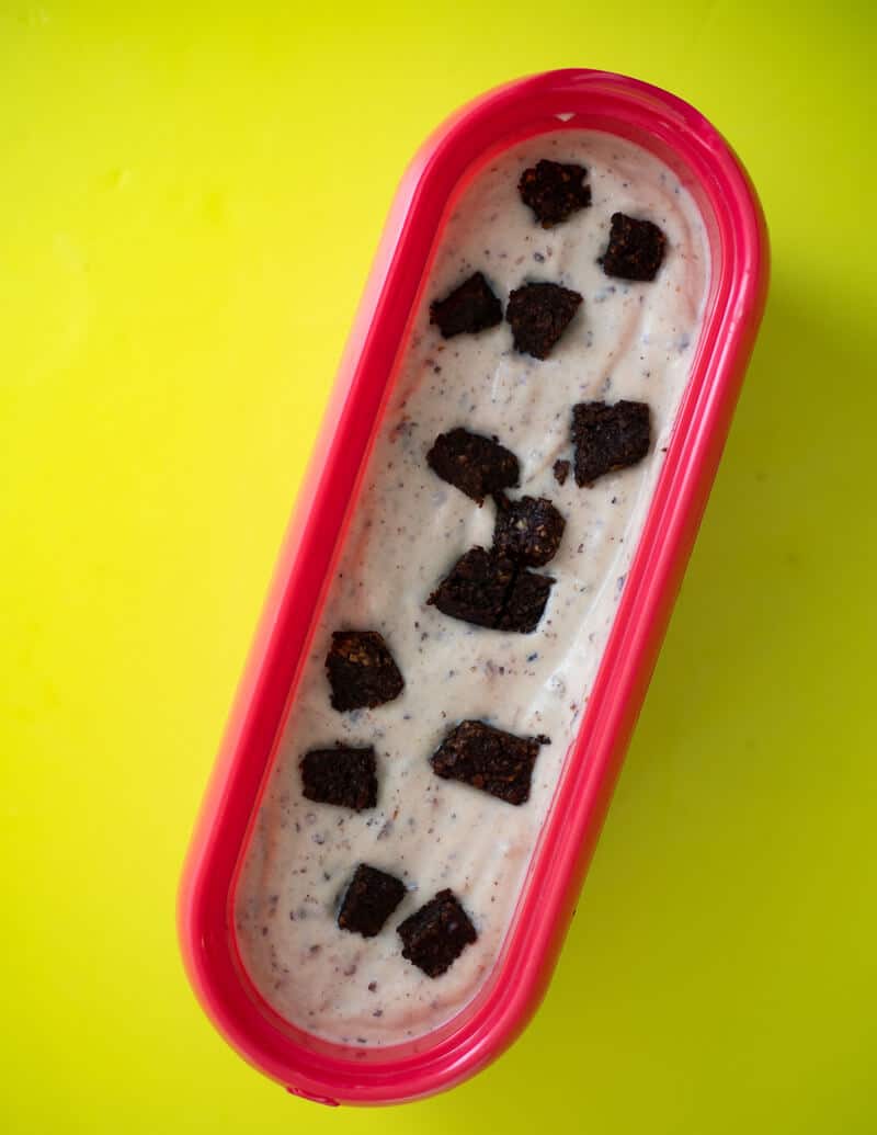 Ice Cream in loaf pan topped with chunks of Trinidad black cake.