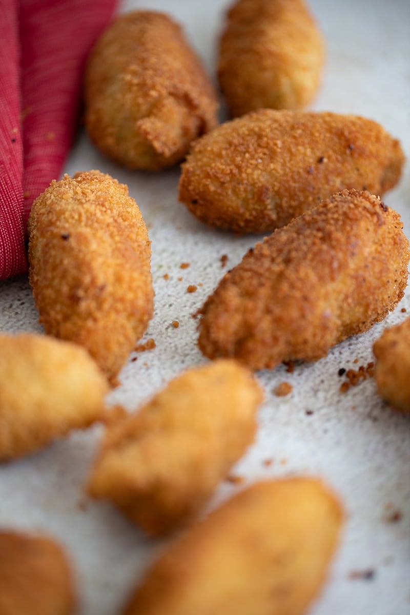 Close-up of golden brown codfish balls showing crispy breadcrumb coating