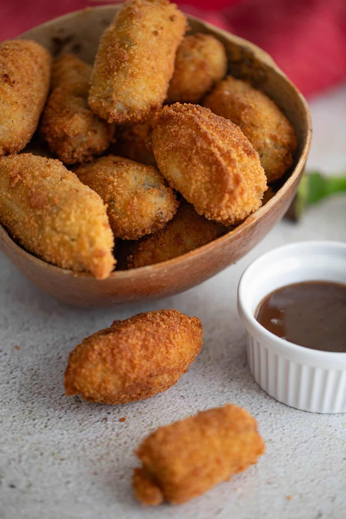 Bowl of saltfish balls served with tamarind dipping sauce.