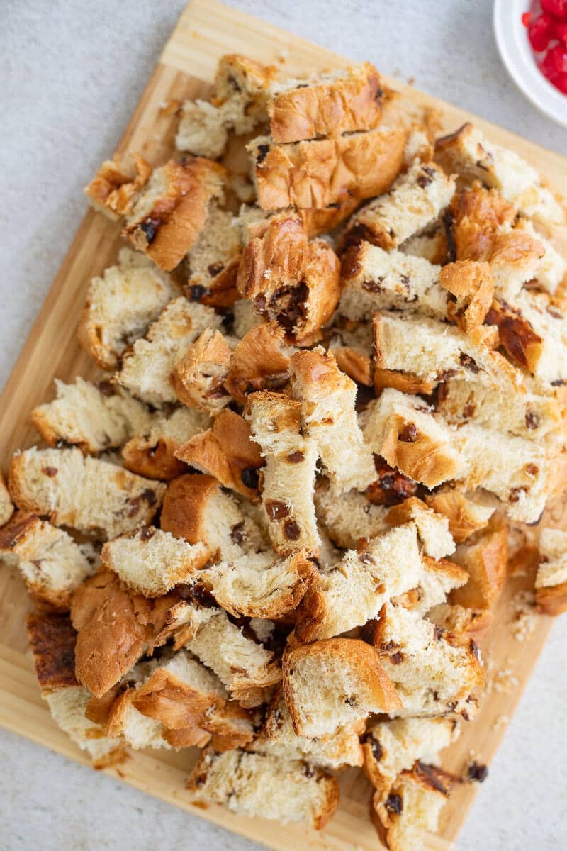 Cubed challah bread on a wooden board.