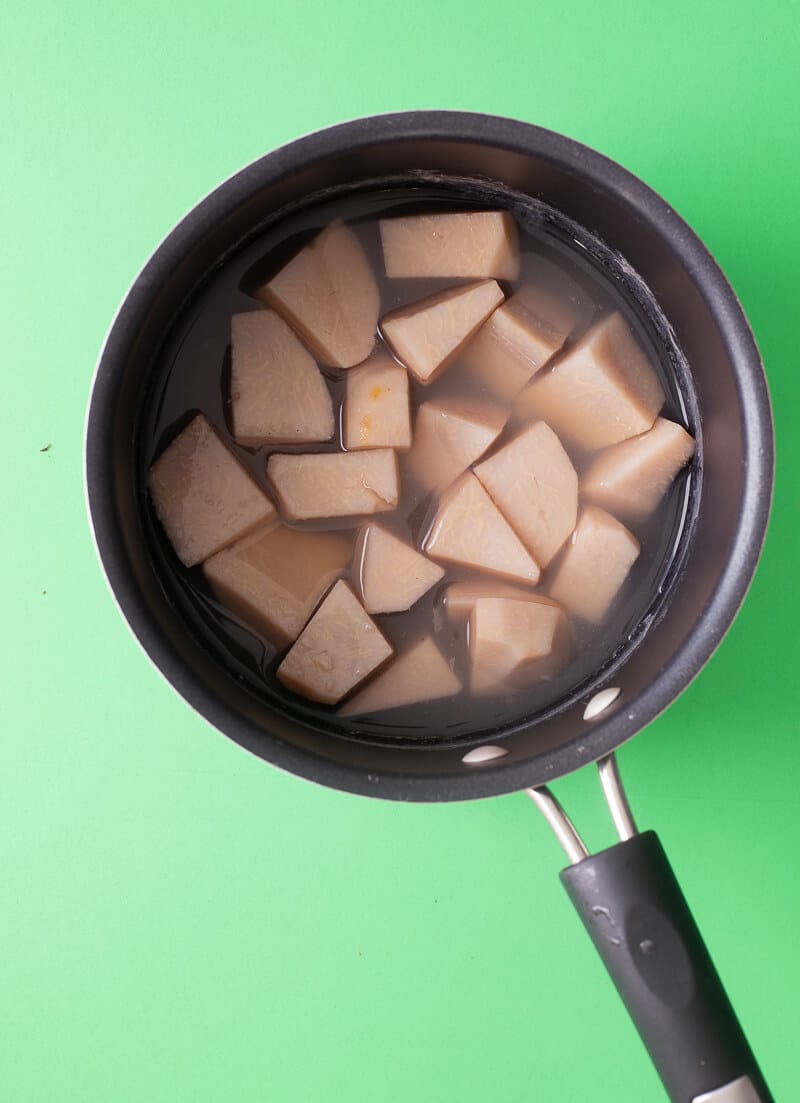 Cubed dasheen boiling in a pot of water to prepare for making punch.