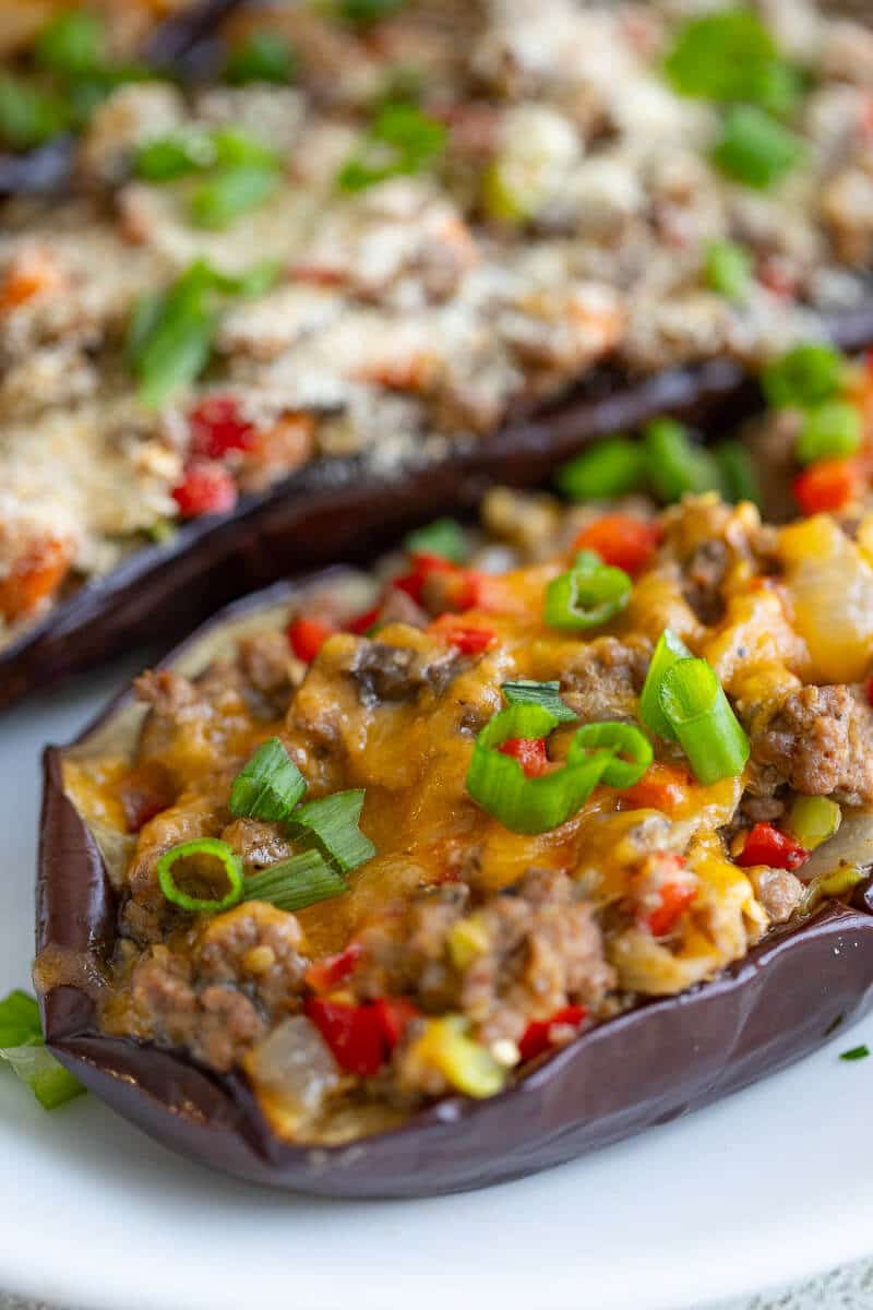 Close up of an eggplant stuffed with meat filling and cheese.