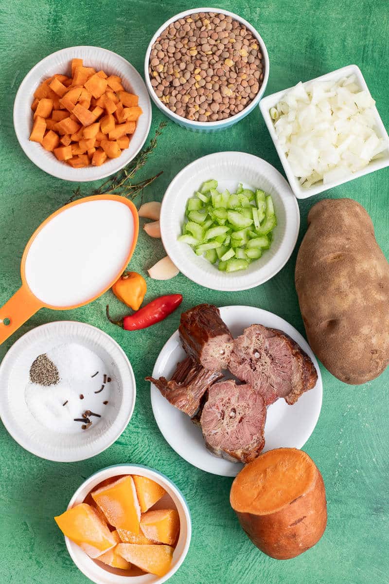 Lentils, pumpkin, sweet potato, potato, onion, celery, garlic, pimento peppers, and salted meat for Caribbean lentil soup