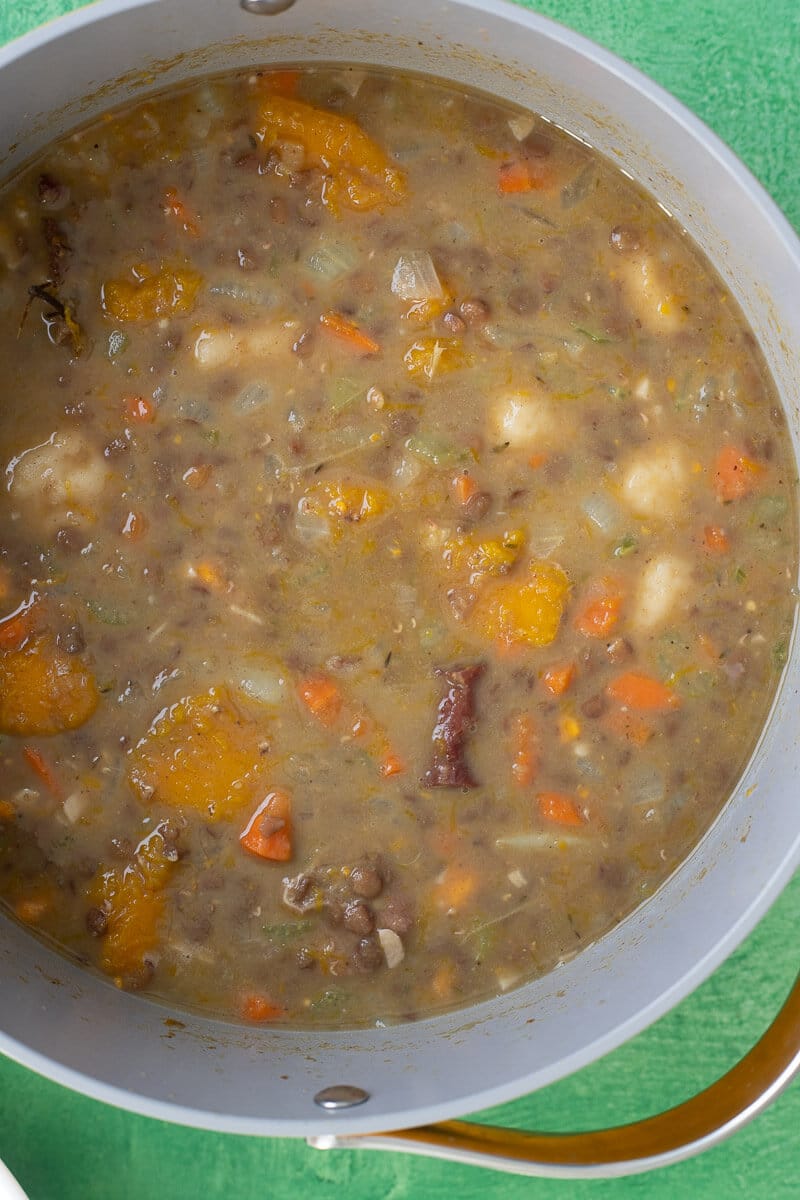 Thick lentil soup with pumpkin, potatoes, and vegetables in a pot