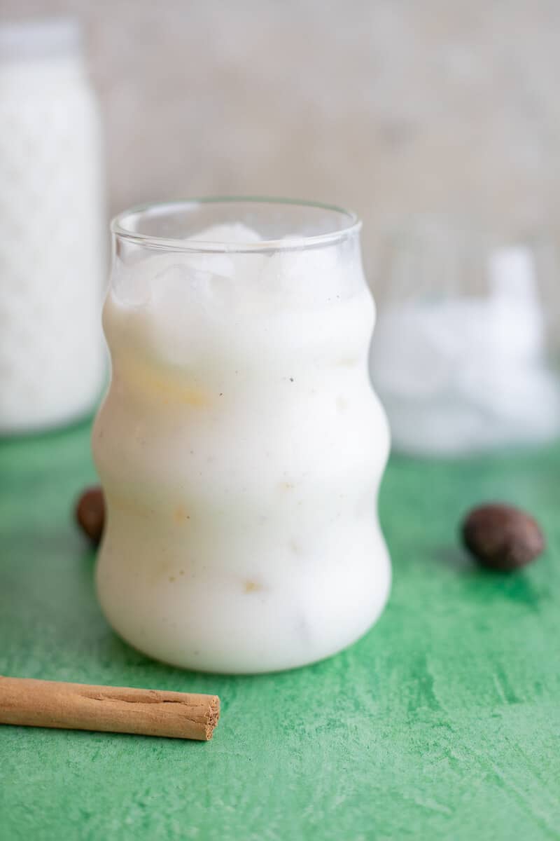 Cinnamon stick and lime peel simmering in water to make spiced base for cassava smoothie