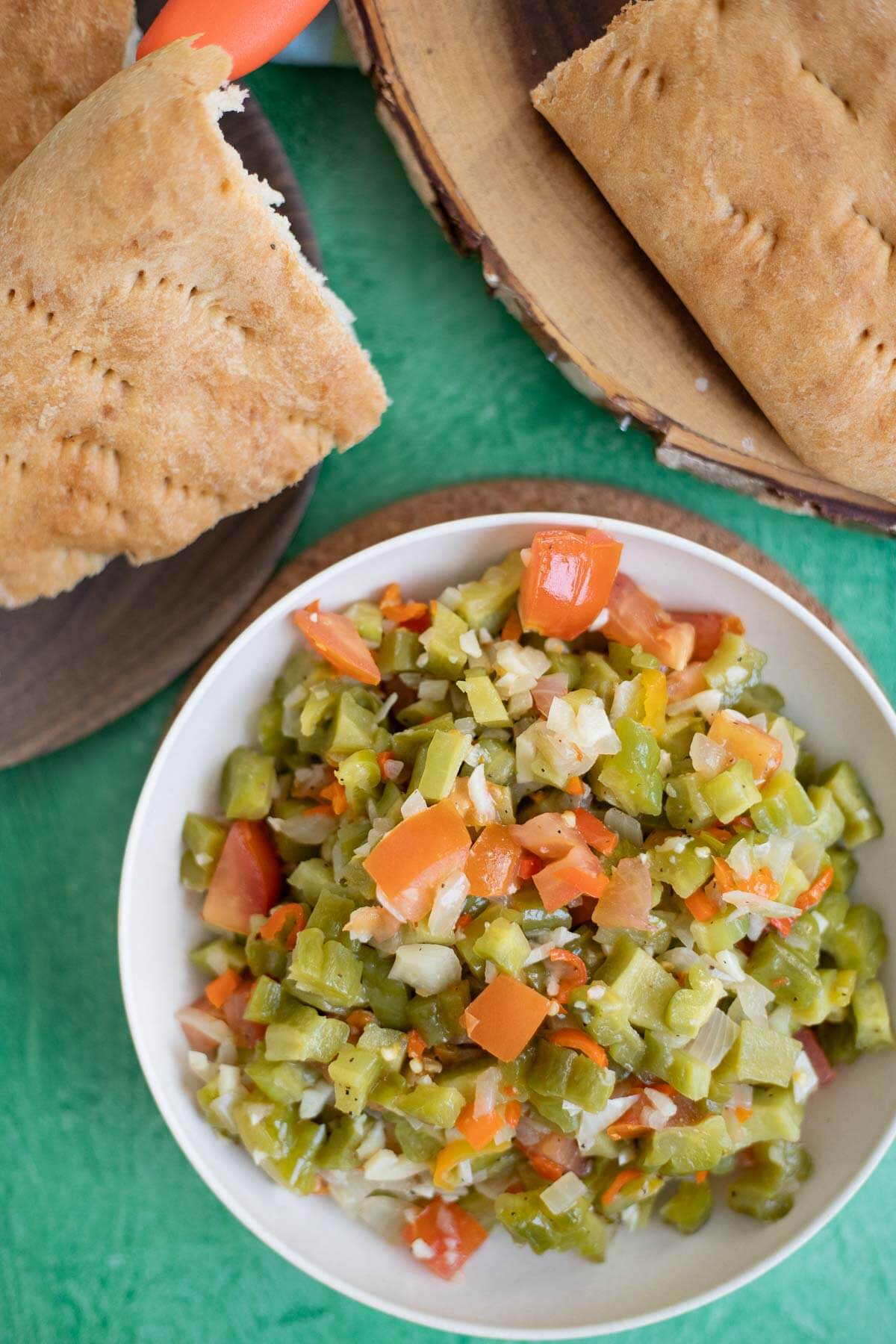 Fried bitter melon caraille served in a bowl with roast bake on the side