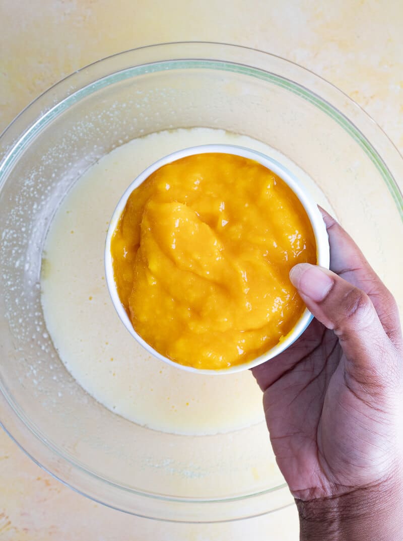 Adding fresh mango puree to batter for bread