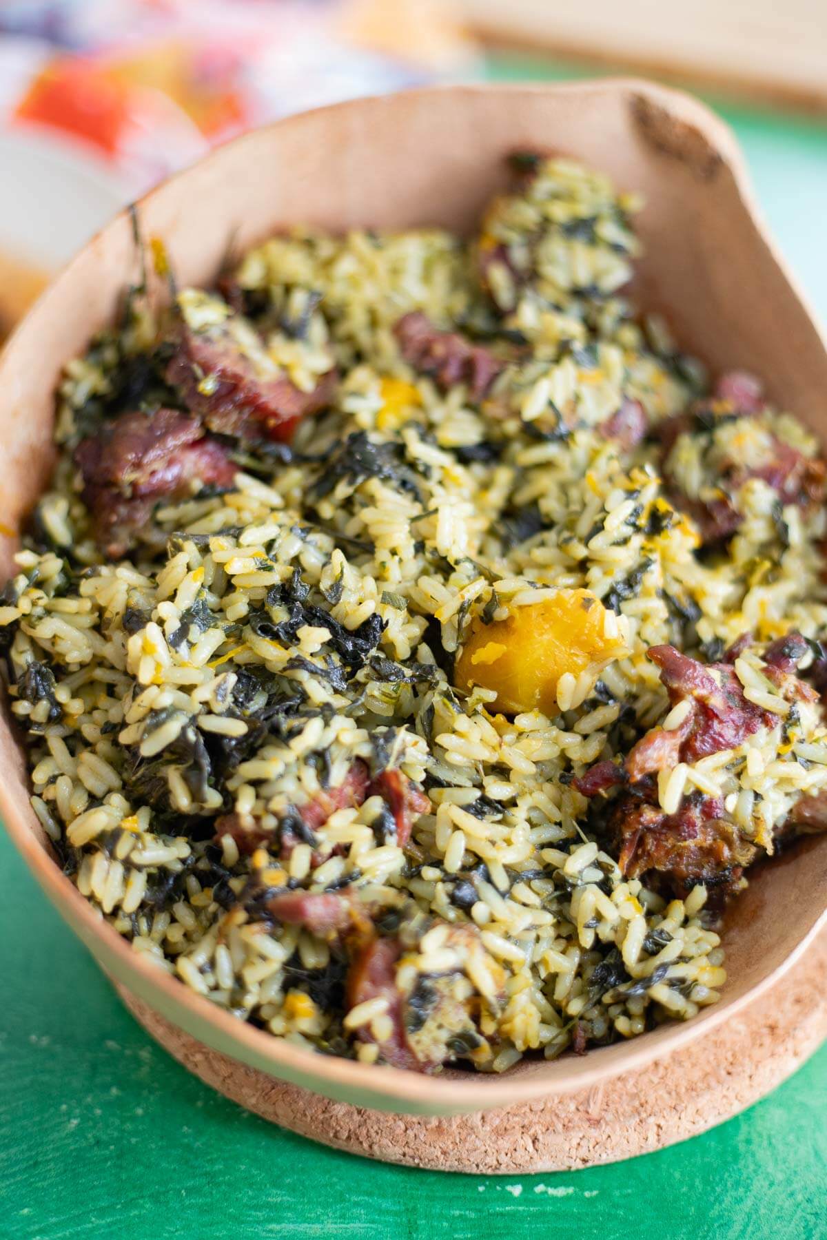 Caribbean bhaji rice made with spinach, pumpkin, and smoked meat in a bowl