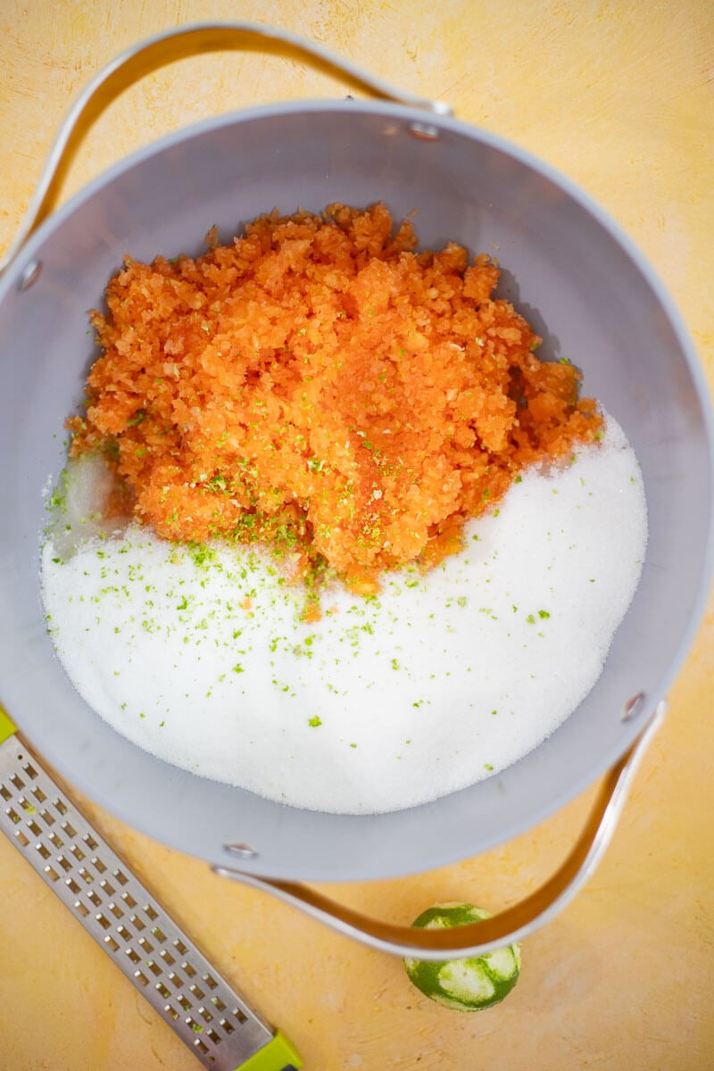 Grated paw paw mixed with sugar and lime zest before cooking