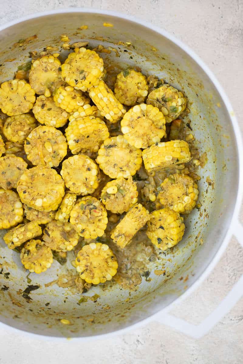 Trinidad curry corn simmered until tender with a thick curry coating.
