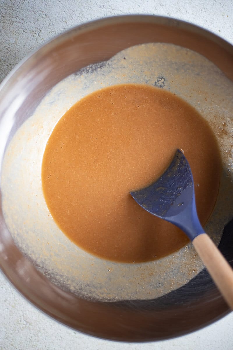 Strained tamarind pulp in a silver bowl.