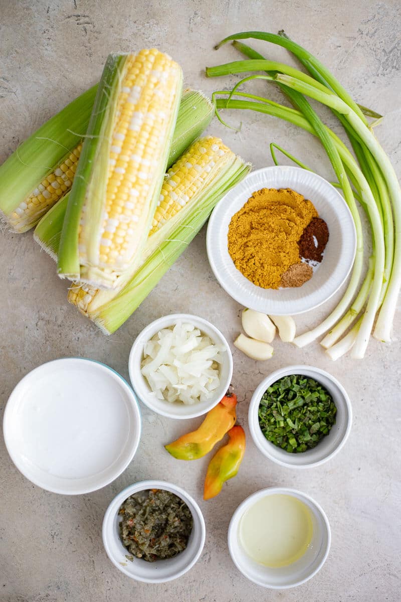 Fresh corn, curry powder, coconut milk, green seasoning, onion, garlic, scallions, chadon beni, and peppers.