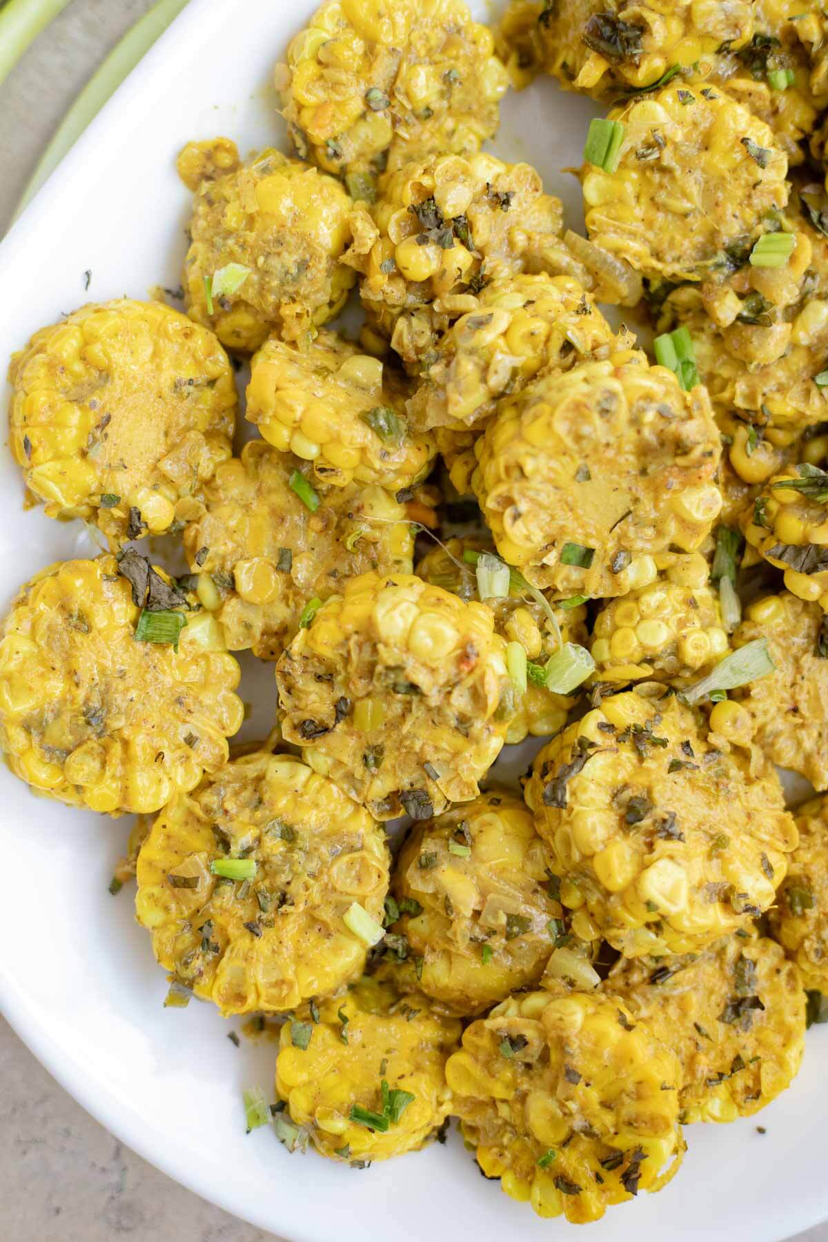 Trinidad curry corn made with fresh corn on the cob simmered in a rich Caribbean curry sauce.