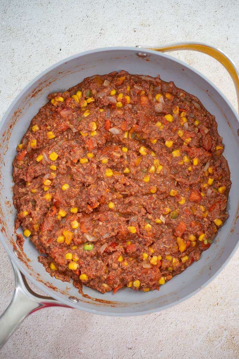 Saucy corned beef mixture with tomatoes, corn, onions, and peppers