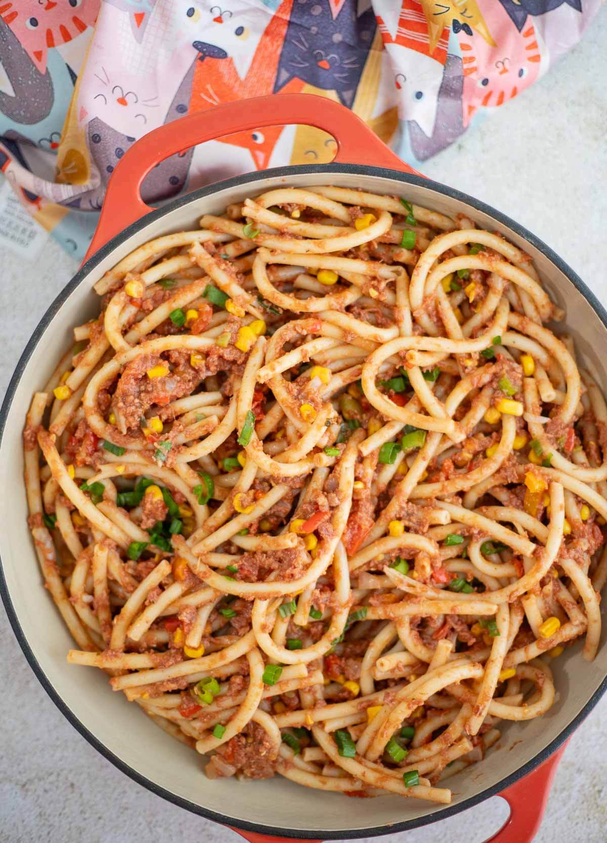 Caribbean-style macaroni and corned beef with corn, peppers, and scallions