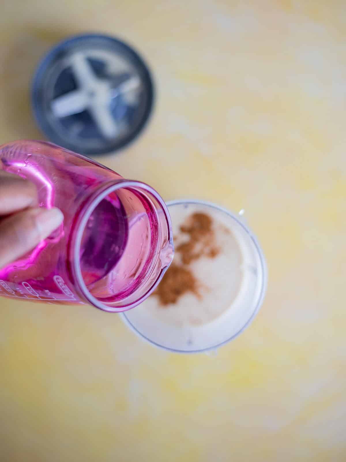 Rum being poured into the peanut ponche de crème mixture