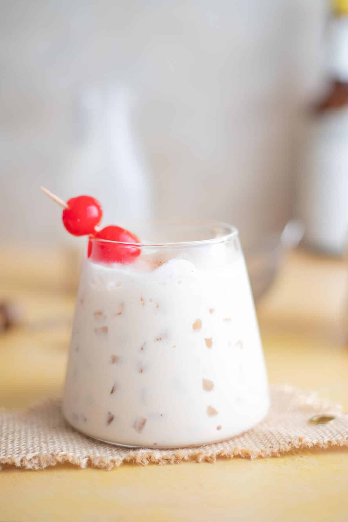 Close-up of creamy peanut ponche de crème served over ice with cherries
