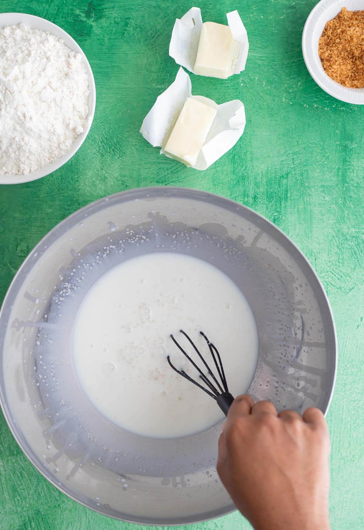 Mixing milk, sugar and yeast for black cake cinnamon roll dough
