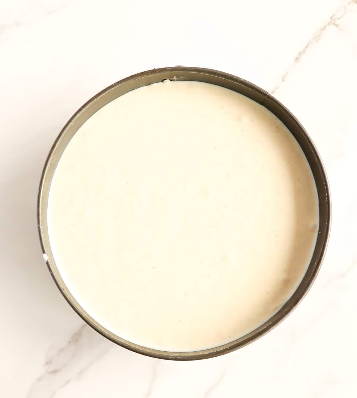 Ponche de crème cheesecake filling in a springform pan before baking