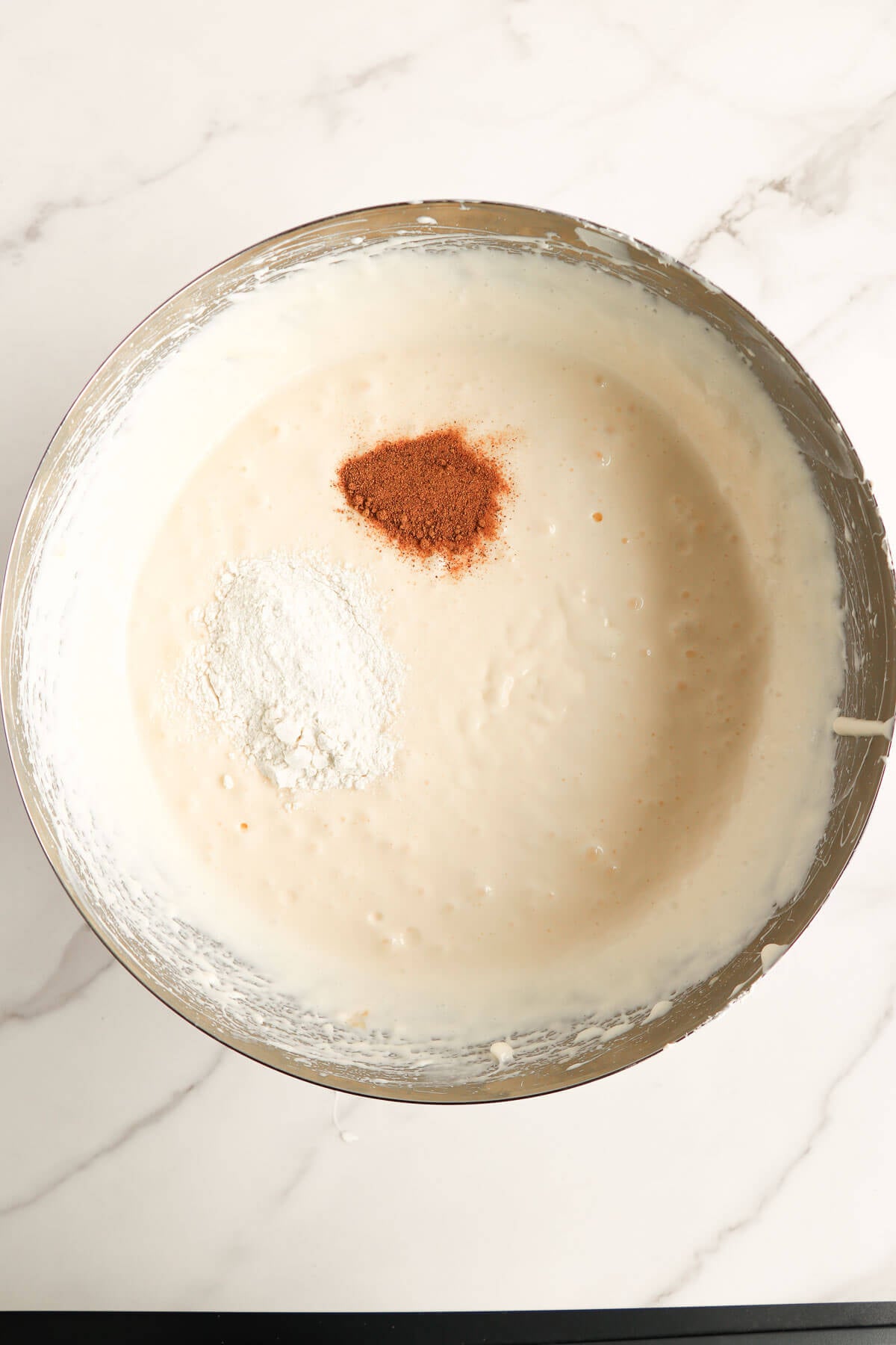 Flour and nutmeg added to ponche de crème cheesecake filling.