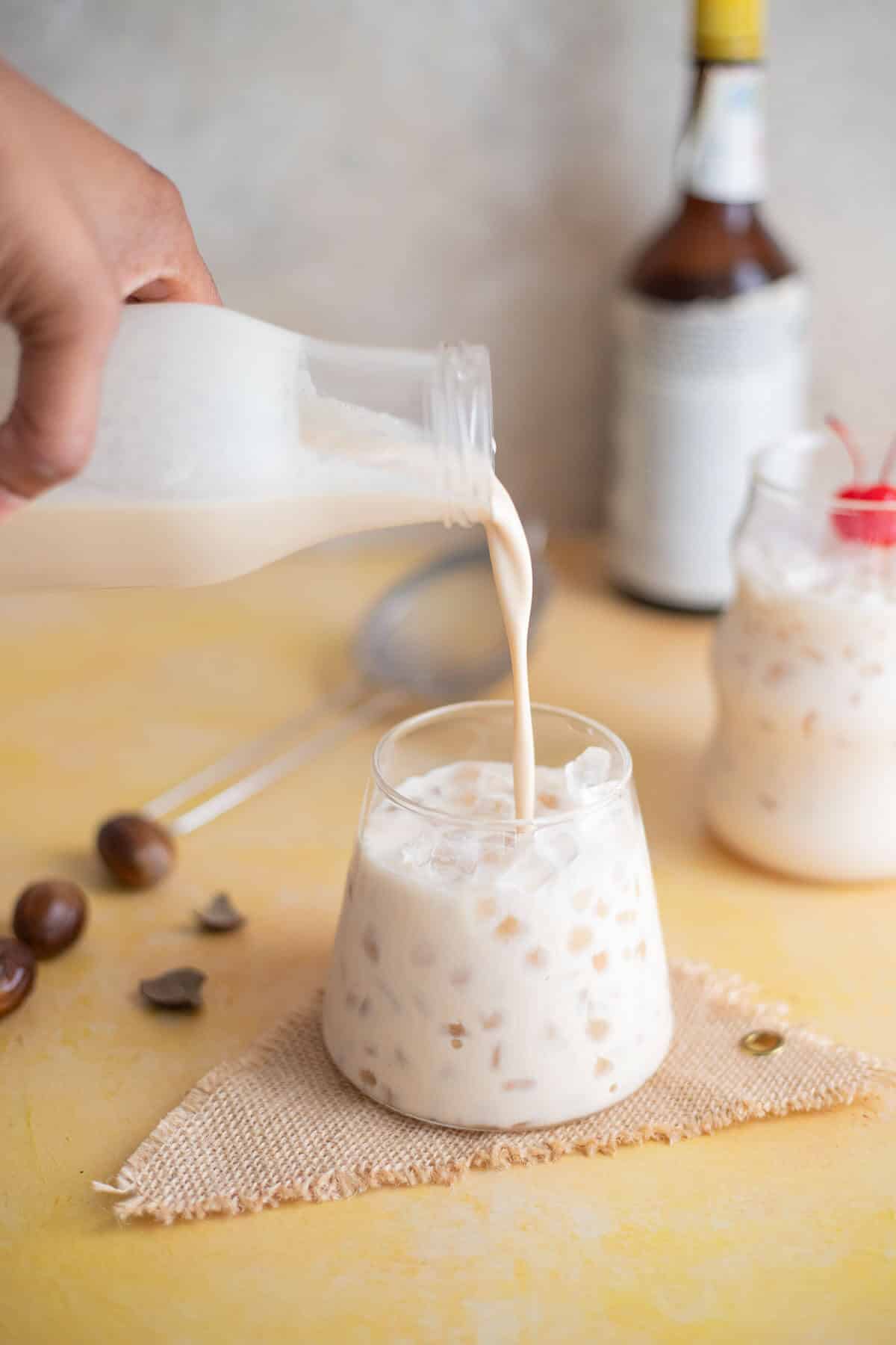 Chilled peanut ponche de crème being poured over ice